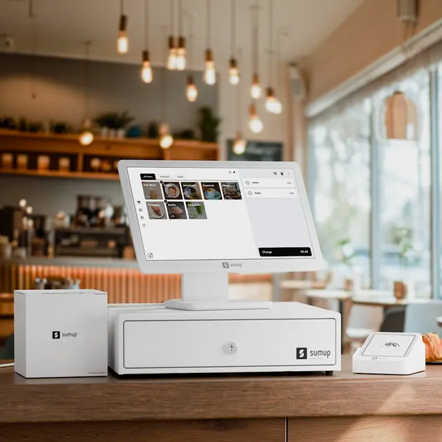 White SumUp retail POS setup with touchscreen register, cash drawer, receipt printer, and card reader on a café counter