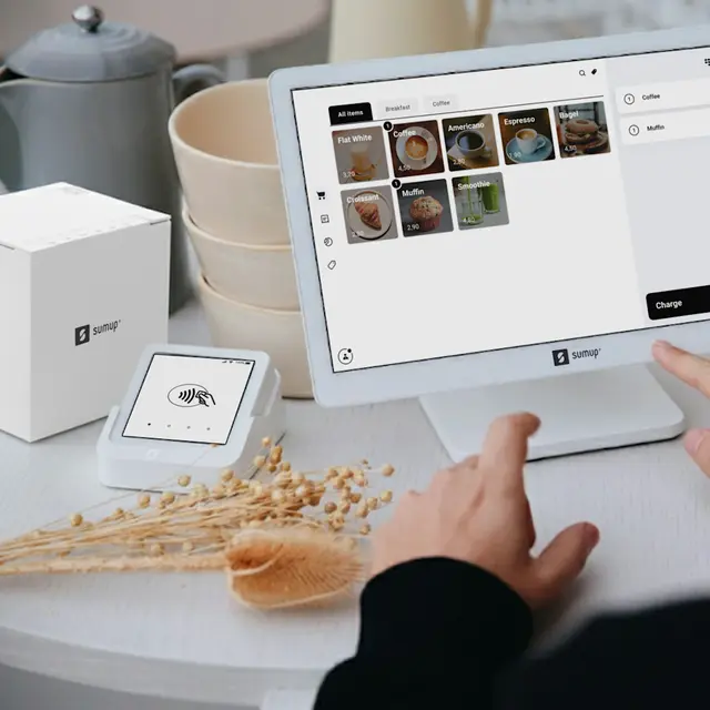 White SumUp retail POS setup with touchscreen register, cash drawer, receipt printer, and card reader on a café counter