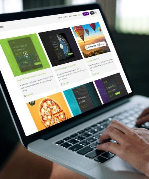 Laptop showing the eMerchantPay website with payment and commerce content on screen